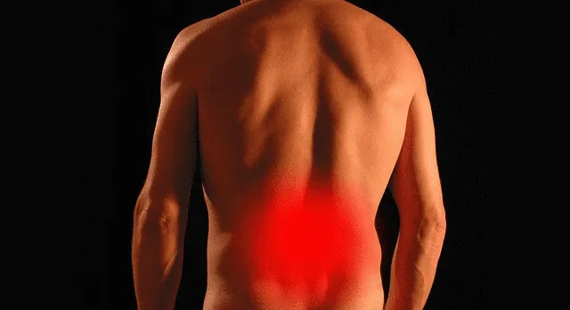 A person experiencing lower back pain, which may benefit from a massage for sciatica.