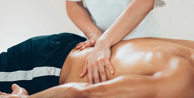 A professional therapist performing a deep tissue massage, effective for sciatica relief.