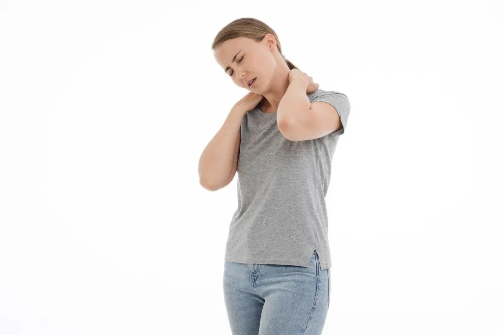 Shows discomfort from strain, highlighting the need for neck pain treatment.