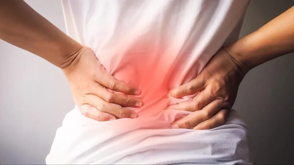 A person experiencing severe lower back pain, a common reason to visit a chiropractor near me for relief.